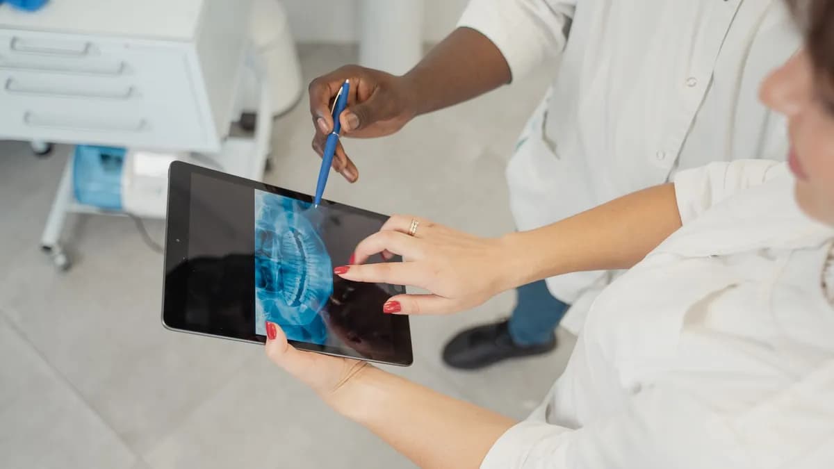 Patient reviewing a proposed smile design on a tablet screen