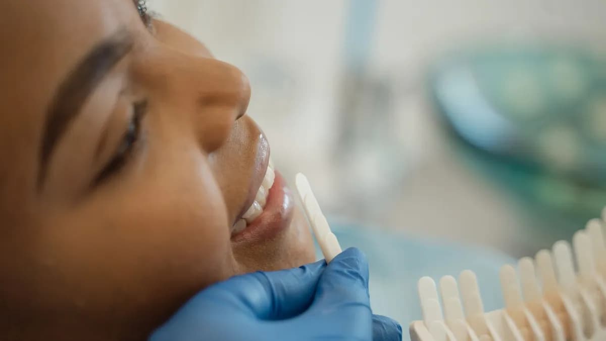 Dentist applying composite bonding to close a gap between front teeth