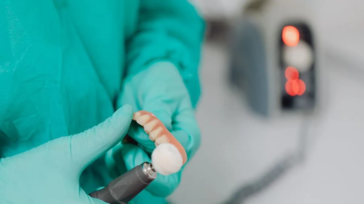 Dental technician crafting a porcelain crown in the lab